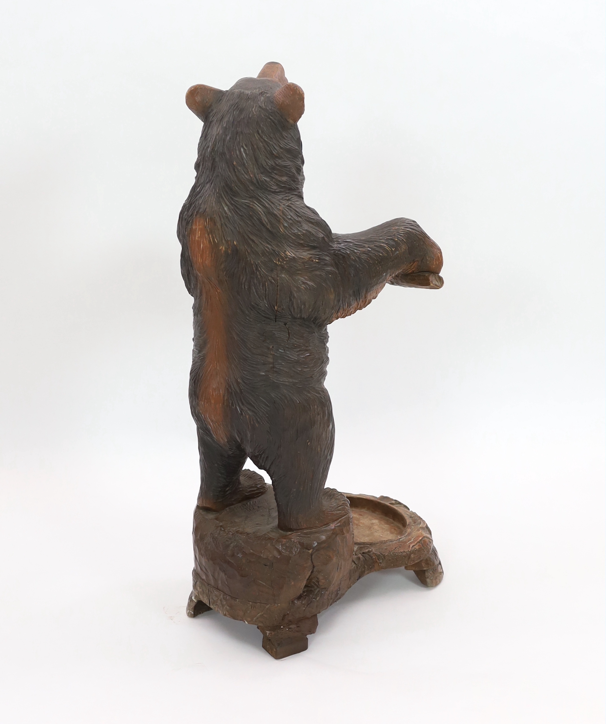 A late 19th century Black Forest carved wood bear stick stand